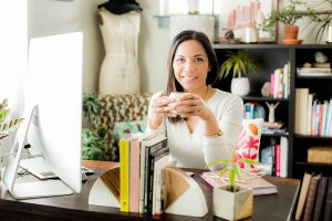 Ruby Somera drinking coffee in her home office